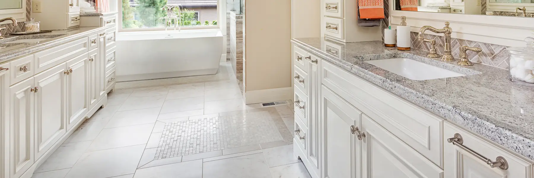 bathroom renovation with two sinks, custom fixtures and cabinets and gray marble vanity